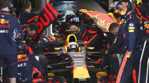 Red Bull mechanics checking Daniel Ricciardo's car