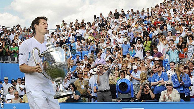 Andy Murray carries the Queen's trophy after winning his first title at the west London club in 2009