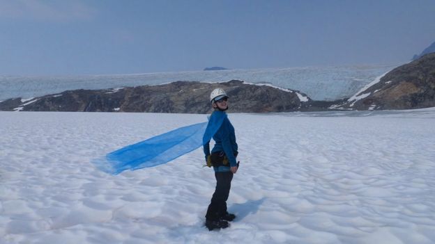 Celeste Labedz posa junto a su capa en el glaciar