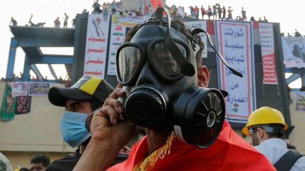 A demonstrator wears a mask to protect himself from tear gas during a protest in Baghdad, October 29, 2019