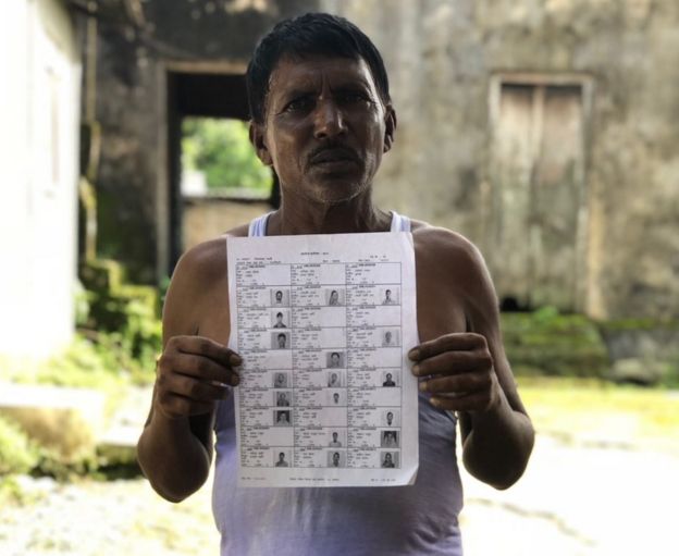A villager holding up a draft list