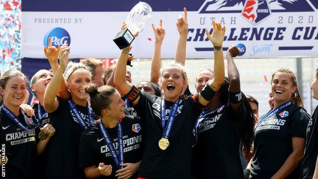 Rachel Daly lifts the trophy after winning the NWSL Challenge Cup Final with Houston Dash