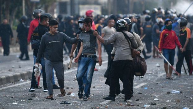Police detain protesters after clashes in Jakarta, Indonesia, early May 22, 2019
