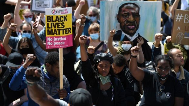 Protesters take the knee in support of the Black Lives Matter movement as they march near Marble Arch in Central London