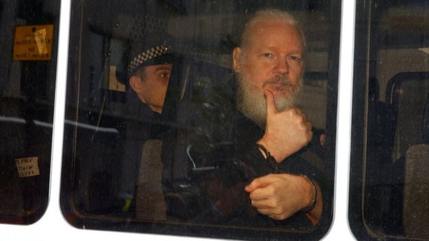 Julian Assange pictured in a police van