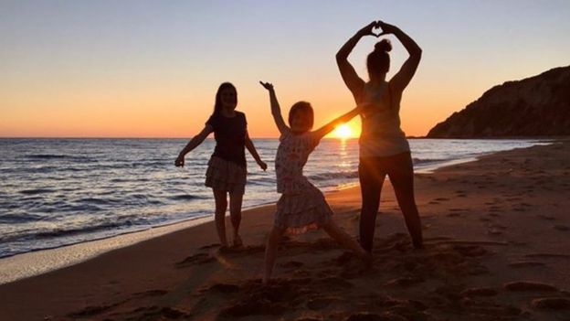 Katie, Shannon and Phoebe Thacker in front of a sunset on the beach