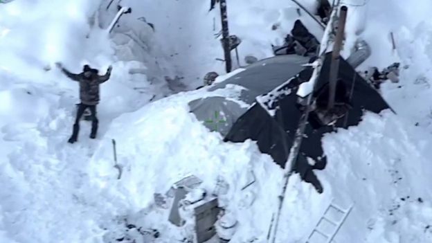 Tyson Steele waving at a helicopter for rescue