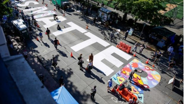 The words 'Black Lives Matter' are painted in the middle of East Pine Street in the Chaz
