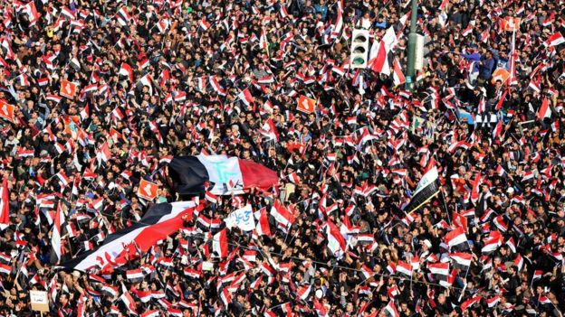 Supporters of Iraqi Shia cleric Moqtada al-Sadr wave national flags and chant slogans during a demonstration at al-Tahrer square, central Baghdad, Iraq, 11 February 2017