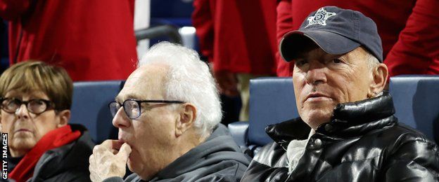 Singer Bruce Springsteen (right) watches the game