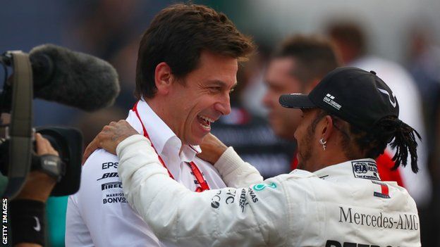 Lewis Hamilton embraces with Toto Wolff