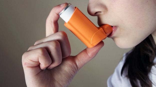 Girl using an asthma inhaler