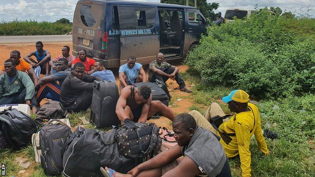 Cameroon rugby league players next to their bus