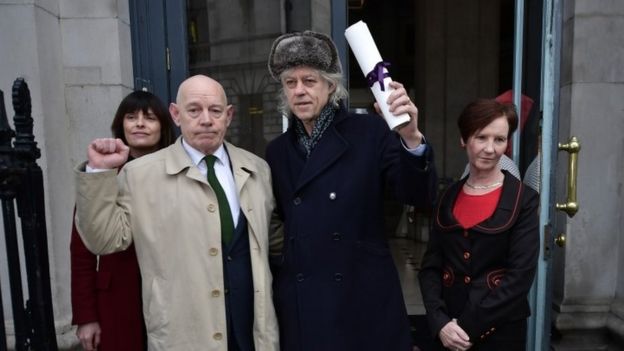 Bob Geldof (centre) hands back his Freedom of Dublin award