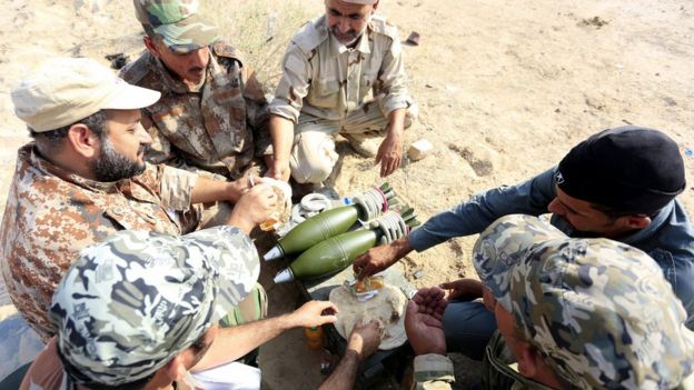 Shia paramilitary fighters take a rest during a live ammunition training exercise in Najaf city, southern Iraq, 14 August 2017