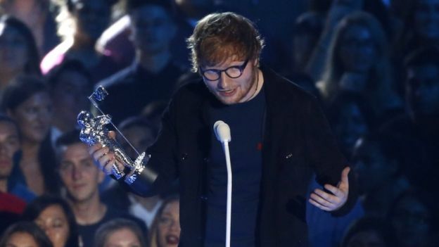 Ed Sheeran on stage with award