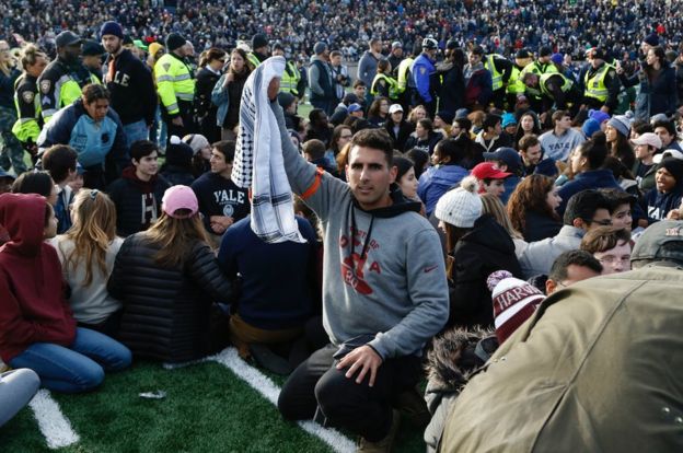 Christian B Tabash raises his fist as part of the Harvard-Yale protest calling on both universities to divest their endowments from the fossil fuel industry