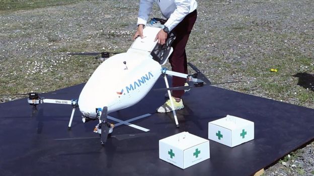 A worker loads a drone with a large rail-guided system