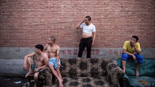 Topless men and a man with the 'Beijing bikini'