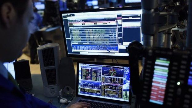 A trader looking at computer screen at New York Stock Exchange