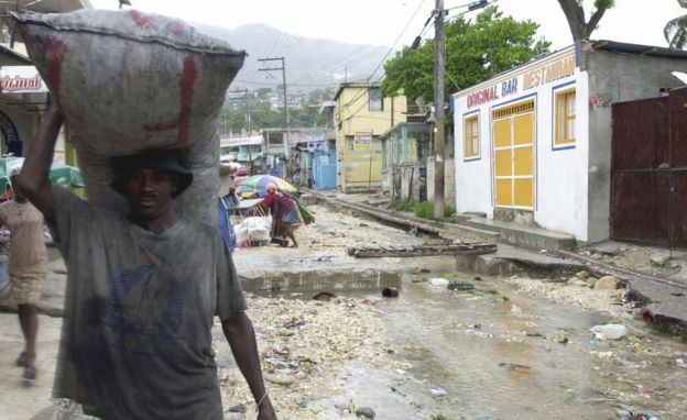 Hombre cargando un saco de carbón