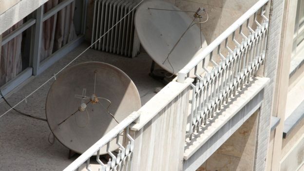 Satellite dishes on a balcony in a northern district of the Iranian capital Tehran (24 July 2016)