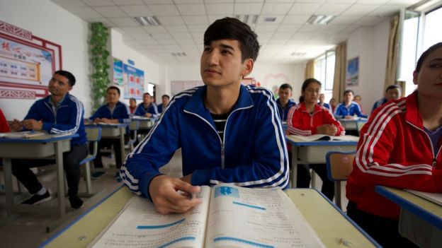 Hombres y mujeres uigures en un aula