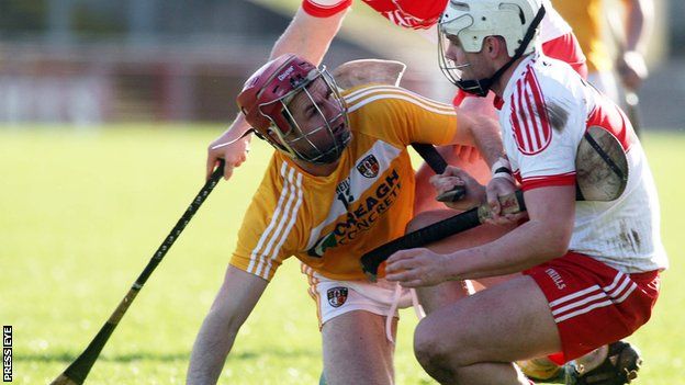 Antrim's Liam Watson has words with Derry player Conor McSorley