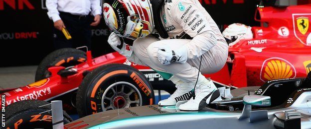 Hamilton celebrates on car