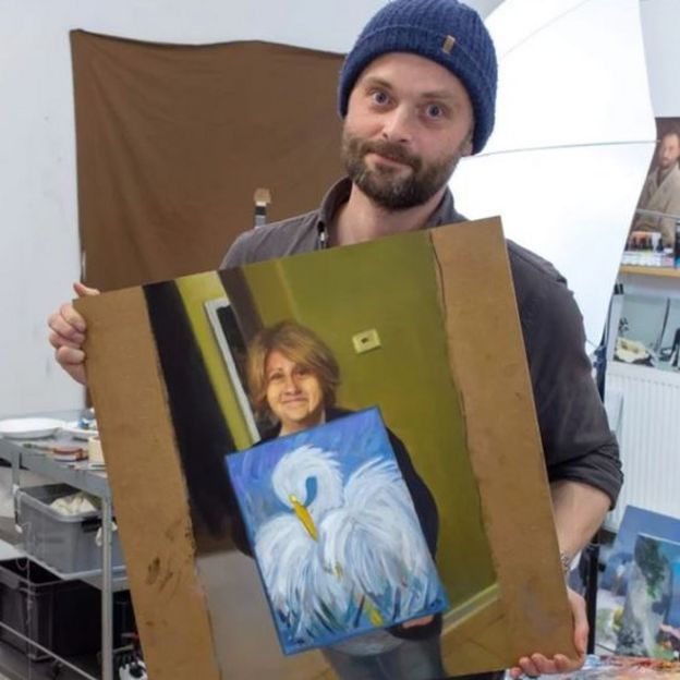 Kristoffer Zetterstrand with his painting of Cindi Decker and her painting