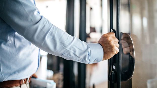 Man with hand on door