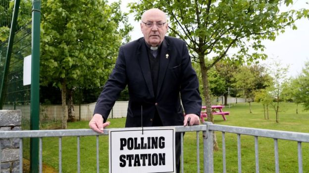 Priest at polling station