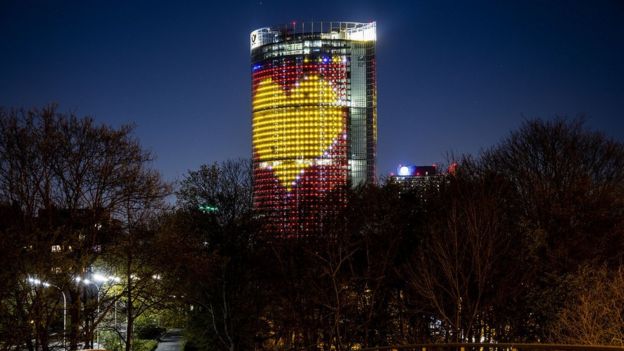 DHL Post Tower illuminated to thank workers during coronavirus crisis. April 5, 2020. Bonn, Germany