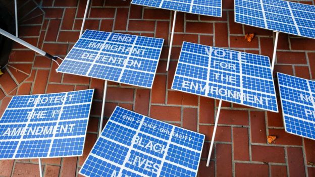 Signs designed to resemble solar panels lie on the sidewalk before the "Rise For Climate" march in downtown San Francisco, California on 8 September 2018.