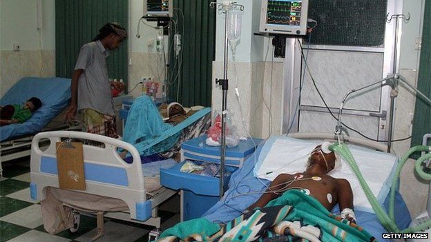 Men lie injured in hospital after being injured in clashes in Aden