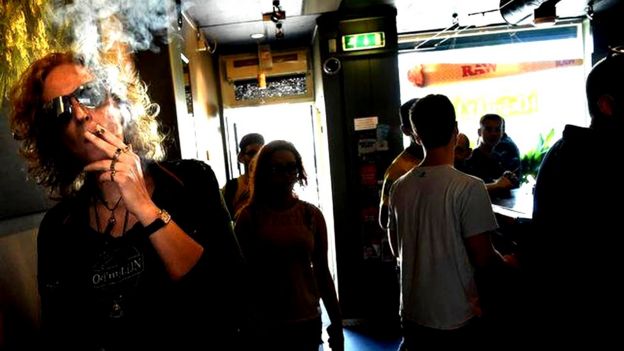 Customers smoke at the Toermalijn coffee shop in the Dutch city of Tilburg