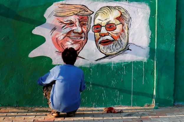 A man applies finishing touches to paintings of U.S. President Donald Trump and India"s Prime Minister Narendra Modi on a wall as part of a beautification along a route that Trump and Modi will be taking during Trump"s upcoming visit, in Ahmedabad, India, February 17, 2020.