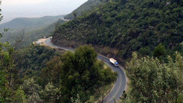 A truck drives on August 21, 2019 on a section of a road leading down the eastern escarpment of the historic Rift Valley, snaking down the cliffside leading from Limuru town