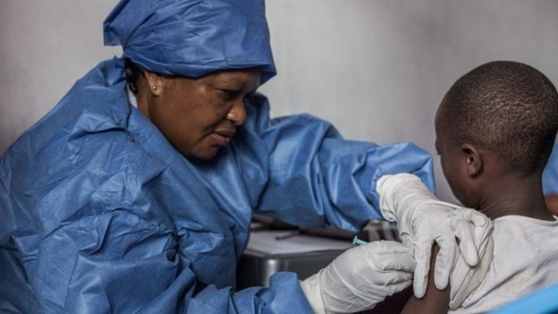 A young girl getting a vaccine against Ebola in the DRC