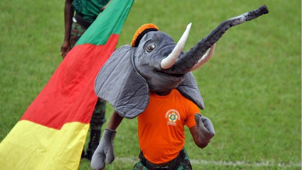 A boy dances dressed as an elephant