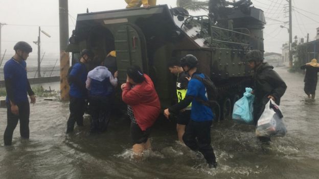 Photo shows residents affected by typhoon Meranti being evacuated on a military armoured vehicle in southern Pingtung county on September 14, 2016