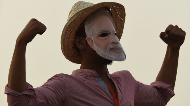 Bharatiya Janata Party (BJP) supporter gestures as Indian Prime Minister Narendra Modi (not pictured) delivers a speech during a rally ahead of Phase VI of India's general election in New Delhi on May 8, 2019.