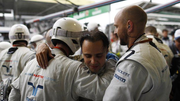 Massa is greeted by members of his own team