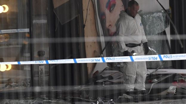 A forensic police officer investigates at the site where a truck slammed into a crowd yesterday outside a busy department store, in central Stockholm, on April 8, 2017