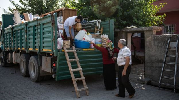 familia sube sus pertenencias a un camión