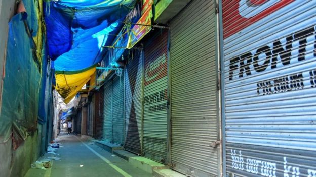 A man walks past closed shops during a shutdown in Srinagar, Kashmir.