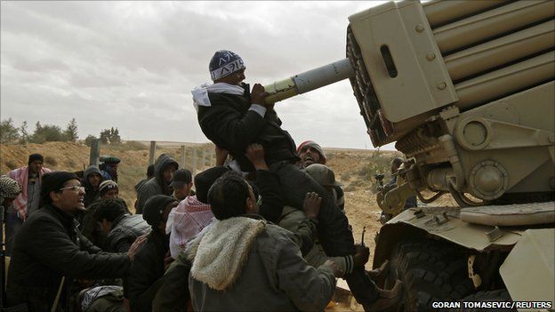 Rebel fighters load a multiple rocket launcher, 9 march 2011