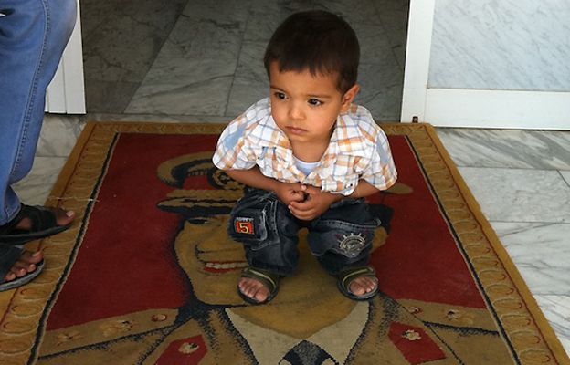 Boy squatting on Gaddafi image, 5 July