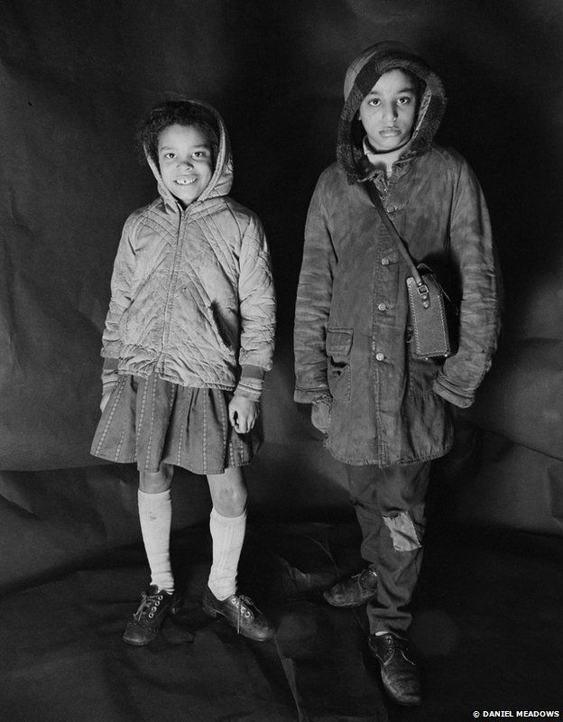 Portrait of Angela Loretta Lindsey, aged 8, with her brother Mark Emanuel Lindsey in Meadows' free photographic shop on Greame Street, Moss Side, Manchester, February - April 1972