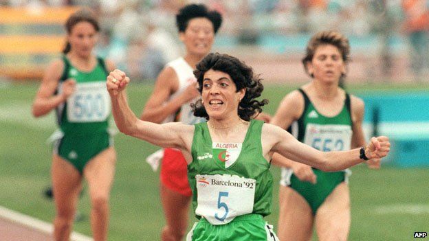Hassiba Boulmerka raises a fist as she crosses the finishing line to win gold in the 1500m in Barcelona in 1992